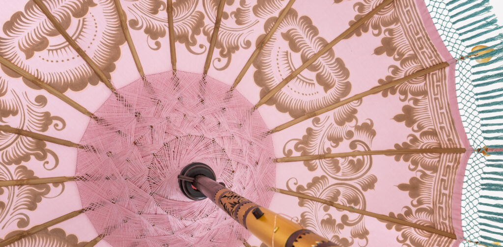 Bali parasol highlighting hand-painted motifs